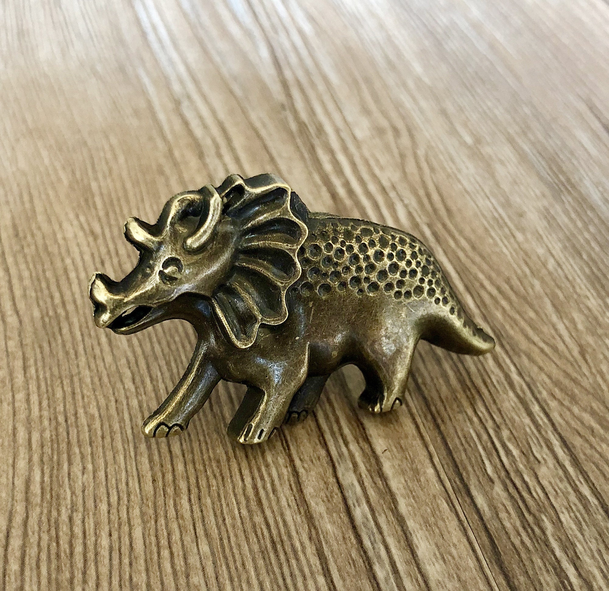 brass dinosaur figurine